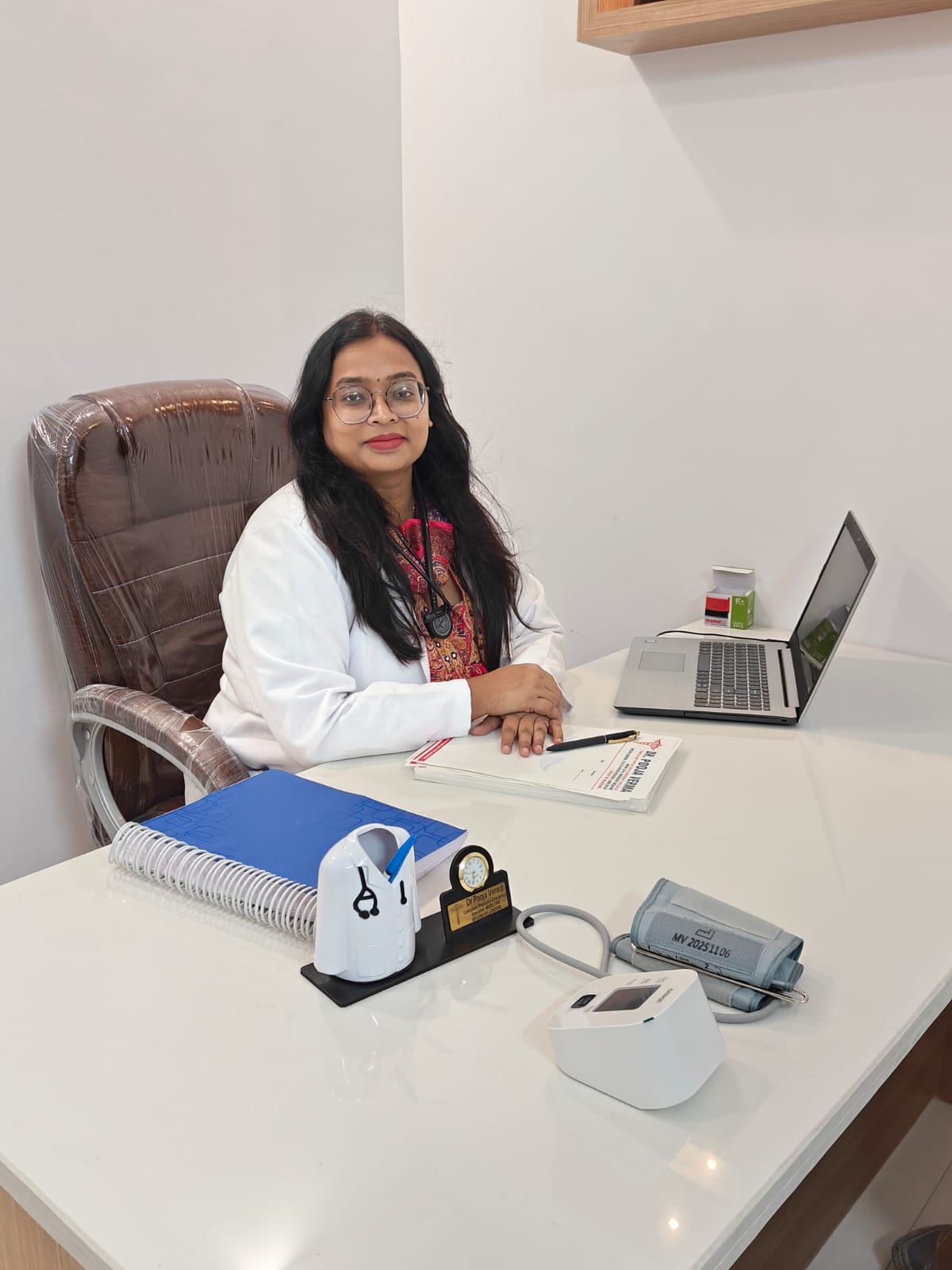 Dr. Pooja Verma smiling in her white medical coat